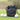 Three leather golf accessory pouches in green, black, and brown colors, displayed on a grass surface with golf balls beside them.